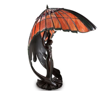 A THREE-LIGHT TIFFANY STYLE TABLE LAMP, 20TH CENTURY the curved shade above an support in the form of a maiden, on a circular