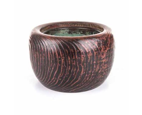 A CHINESE RED AND BLACK LACQUER JARDINIÈRE of circular form, with a conforming bronze liner 24cm high 