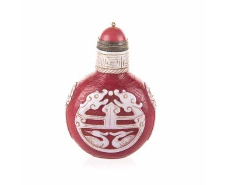 A CHINESE WHITE OVERLAY PEKING GLASS SNUFF BOTTLE the red body carved with waves, overlaid with 'Chilong' and cranes, the nec