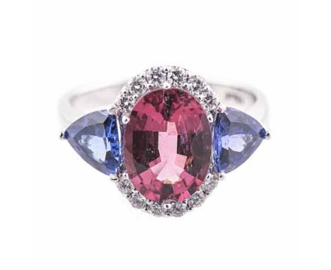 A PINK TOURMLAINE, TANZANITE AND DIAMOND RING centred with an oval mixed-cut pink tourmaline weighing approximately 2.36cts, 