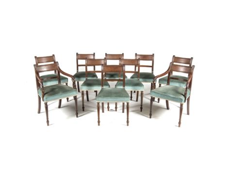 A SET OF TEN REGENCY STYLE MAHOGANY DINING CHAIRS comprising: eight side chairs and a pair of carvers, each fluted and carved