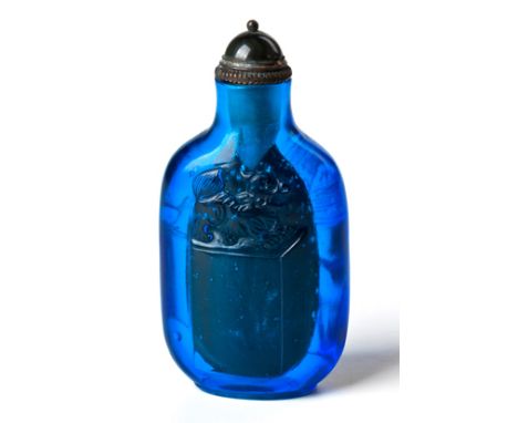 A CHINESE COBALT BLUE PEKING GLASS SNUFF BOTTLE on a short oval foot, the ovoid body carved with scholar’s seals mounted with