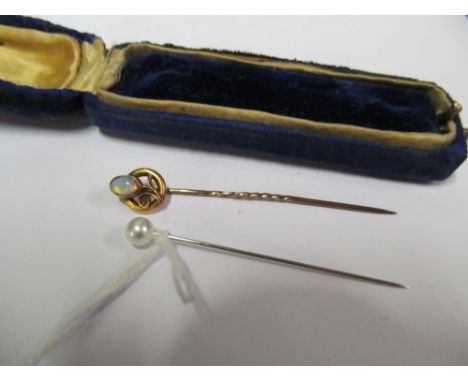 A 15ct gold stick pin set opal flower and another simulated pearl stick pin