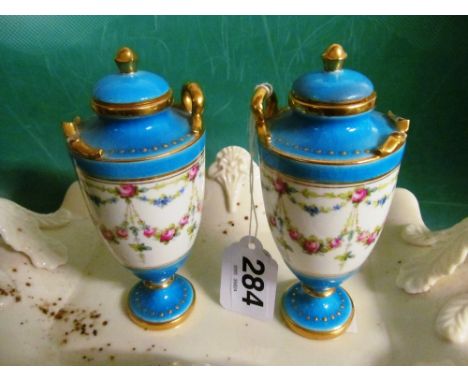 A set of six teacups and saucers made for Bentalls with rose swag design, a pair of Minton small lidded two handled vases ros