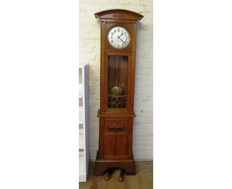 An oak Arts and Crafts style longcase clock, silvered dial and two brass weights