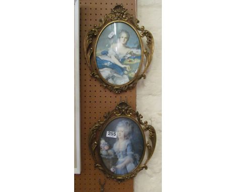 A pair of brass frames with material portrait inserts