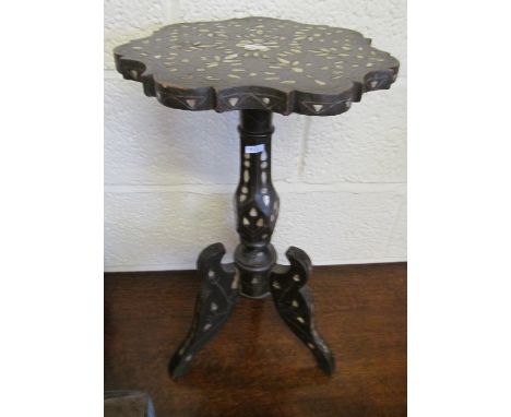 A small table with mother of pearl decoration