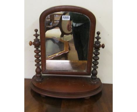 A Victorian swing mirror on bobbin turned supports
