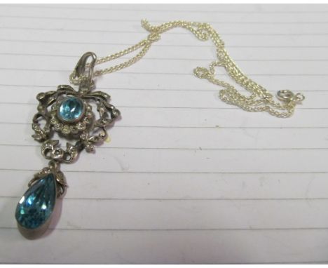 A silver coloured pendant set turquoise and white coloured stones and a Balmoral coin and pearl effect necklace