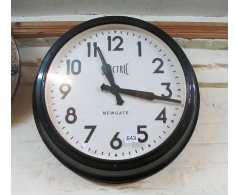 A large metal framed wall clock marked Electric Newgate