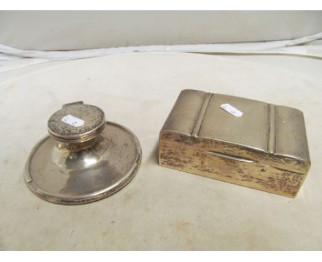 A silver inkwell and cigarette box