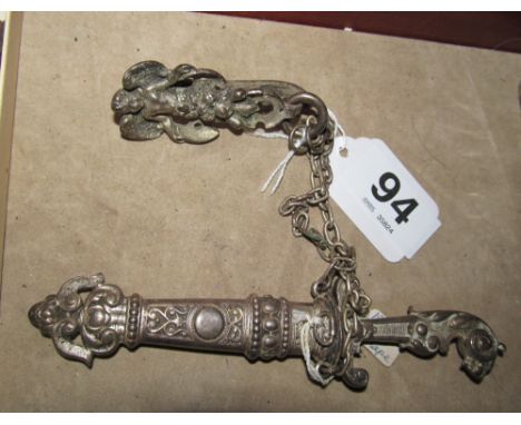 A small East European dagger in metal scabbard with lion head handle on a chain with cherub clip