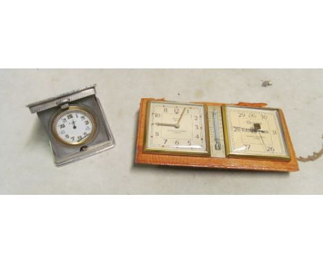 A small silver travelling clock and a Negretti &amp; Zambra clock barometer (stand a/f)