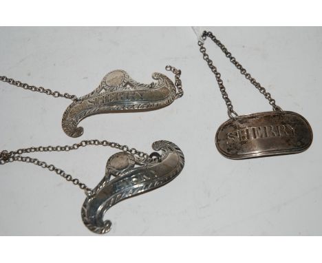 A lot comprising a pair of white metal decanter labels Sherry &amp; Whisky and a silver label, Sherry, Glasgow hallmarks Cond