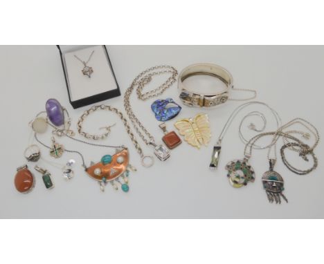 A silver buckle shaped bangle, two silver gemstone inlaid Aztec style pendants and other items Condition Report: Not availabl