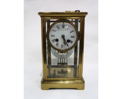 A large brass mantle clock with floating drum head and mercury filled pendulum, the movement marked 1018, 25cm high Condition