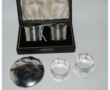 A lot comprising two pairs of silver napkin rings and a compact Condition Report: Available upon request