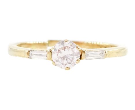 18ct gold three stone round brilliant cut and baguette cut diamond ring, principal diamond approx 0.25 caratCondition Report: