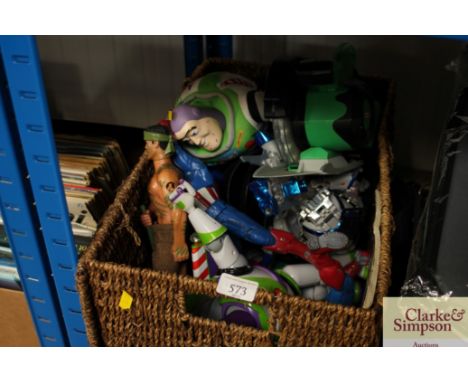 A basket of various children's toys to include Buzz Lightyear and Action Man