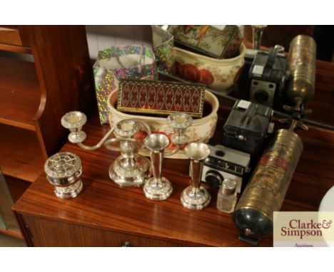 A vintage fire extinguisher together with a candelabra; a camera; a vintage tin; silver topped bottle etc