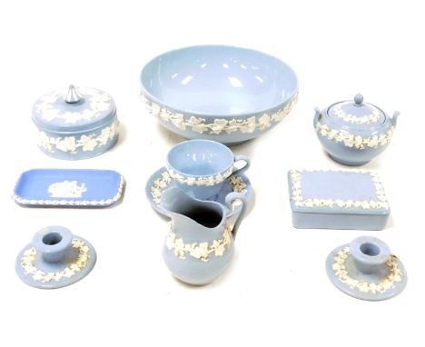 A group of Wedgwood Embossed Queens ware pottery, including a fruit bowl, sucrier and cream jug, and a pair of chamber sticks