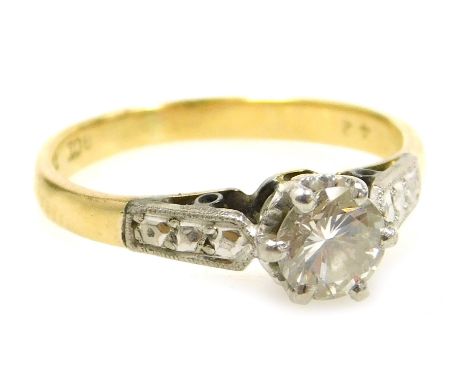 A diamond solitaire ring, set in white and yellow metal, high claw set, stamped 18ct and plat, approximately 0.5ct, size J/K,