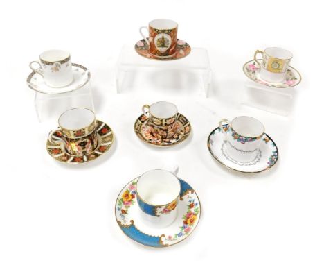 A group of coffee cans and saucers, variously decorated by Royal Worcester, Royal Crown Derby, Royal Doulton and others. (qty
