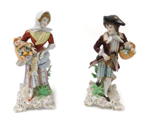 A pair of 20thC Sitzendorf porcelain figures, modelled as a gallant with game bird and basket of flowers, and a lady with a b