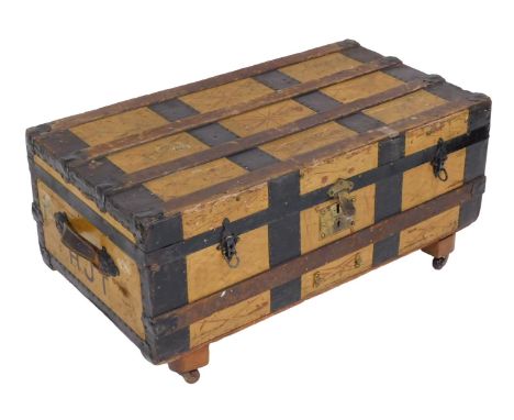 A Victorian iron bound and painted trunk, with leather carrying handles, bears luggage labels, on castors, 30cm high, 87cm wi
