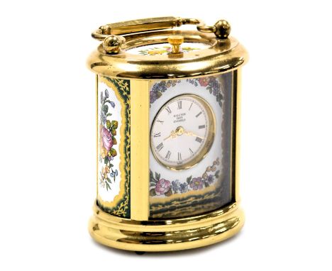 A Halcyon Days brass and enamel table clock, decorated with floral panels, 8.5cm high.