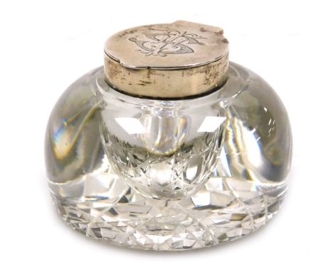 An Edward VII cut glass and silver mounted inkwell, with a hinged lid, monogram engraved, London 1902.