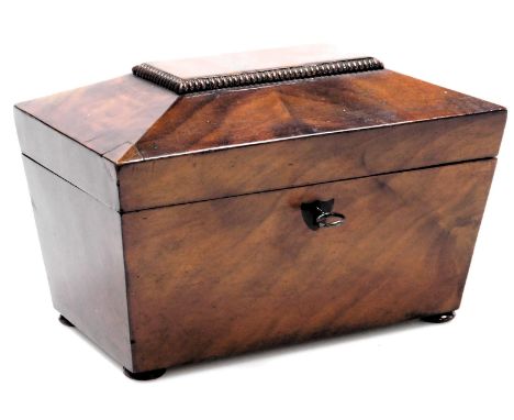 A Regency mahogany sarcophagus form tea caddy, the hinged lid opening to reveal two lidded compartments, raised on bun feet, 