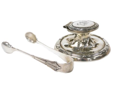 An Edward VII silver loaded inkwell, monogram engraved, Birmingham 1908, together with a pair of George V silver sugar tongs,