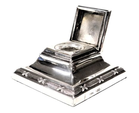 An Edward VII loaded silver inkwell, of outswept square form, with glass liner, Chester 1909, 5.46oz all in.