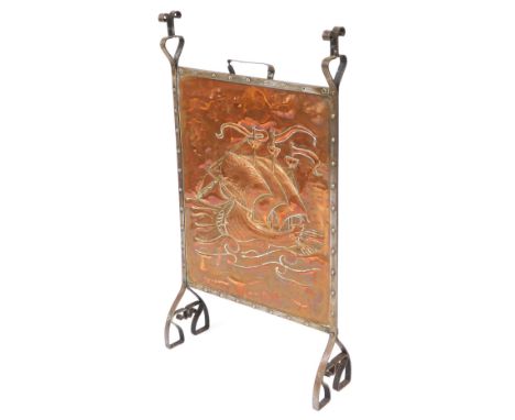 An late 19thC Arts &amp; Crafts copper and cast iron framed firescreen, possibly Newlyn School, the central panel embossed wi