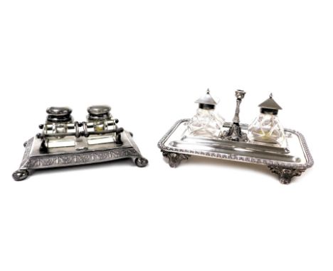 A Victorian silver plated desk stand, of rectangular form, with a gadrooned rim, enclosing two pen recesses, and a pair of cu