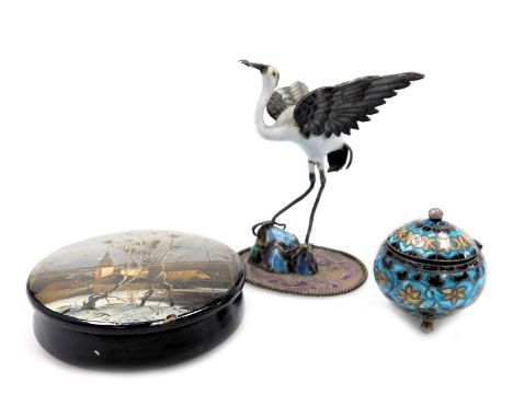 An early 20thC silver and enamel figure of a stork, modelled perched on a rock, 7cm high, continental white metal and chample