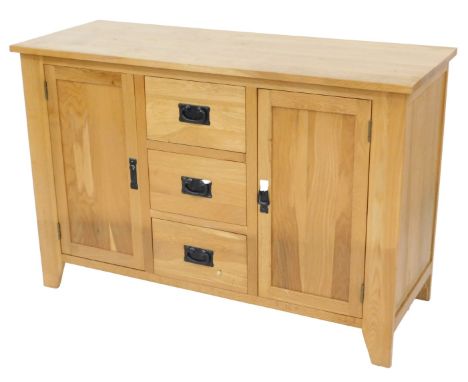 A small light oak sideboard, with three drawers and two panelled doors, on stiles, 119cm wide.