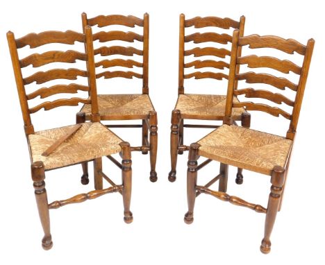 A set of four Titchmarsh &amp; Goodwin oak rush seated ladder back single dining chairs.