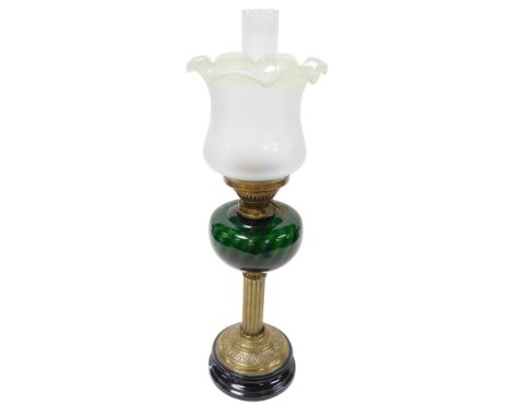 An early 20thC brass oil lamp, with a green glass reservoir, on a black socle, with chimney and Art Nouveau frosted to green 