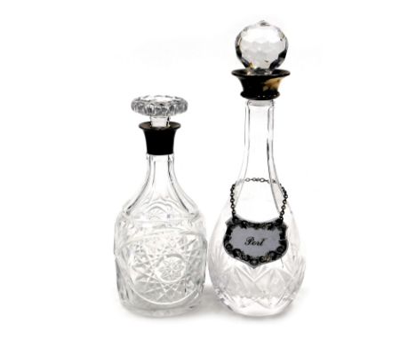 An Elizabeth II cut glass and silver mounted decanter, and stopper, Birmingham 1955, and a further decanter and stopper, with