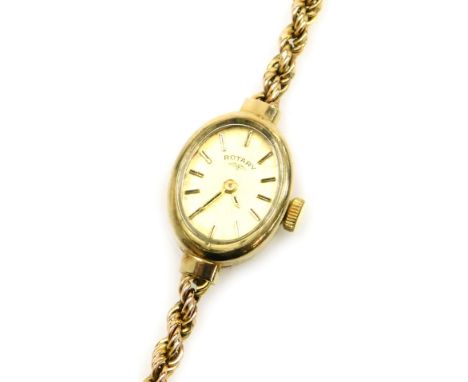 A Rotary lady's 9ct gold cased wristwatch, oval champagne dial with gilt batons, in an oval casing, on a 9ct gold rope twist 