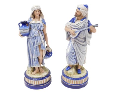 A pair of late 19thC Continental porcelain figures, of a North African gentleman playing a lute, and a woman water carrier, e