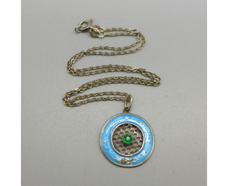 An enamelled and stone set pendant on a silver chain, the pendant tests as silver, enamel a/f 