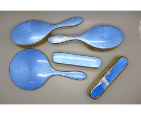 Six pieces of silver and blue enamel; five brushes and a hand mirror, (two brushes and hand mirror enamel a/f) 
