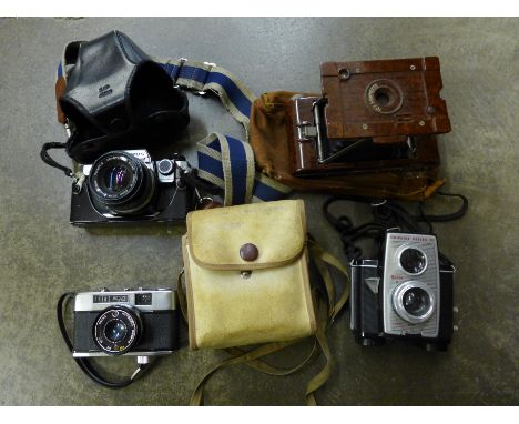 Four 35mm film cameras, Olympus OM10, Prinz, Bakelite cased Hawkette and Kodak Brownie Reflex 