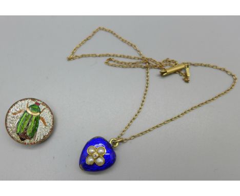 A blue enamel, seed pearl and diamond set heart shaped memorial pendant on a fine 9ct gold chain, enamel and back glass a/f, 