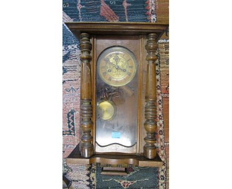 An early 20th century mahogany cased Vienna wall clock, with pendulum and key, 22 long A/F