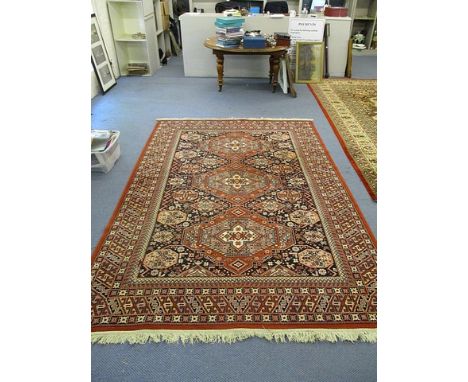 A Persian style, machine woven carpet with geometric motifs on black ground, 116 x 78