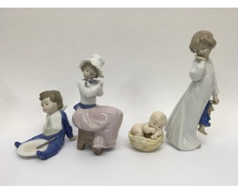 A collection of 4 Nao figurines depicting babies, a young girl and a girl with a puppy.